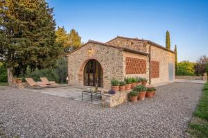 a stone building with chairs and potted plants at Chianti Escape PoolVines Tenuta Bibbiano-I Sodi in Castellina in Chianti +92 photos
