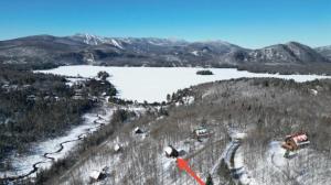 an aerial view of a snow covered mountain with a lake at Le Bois Dormant - Spa, Fireplace, Pool, Lake, Tennis in Lac-Superieur