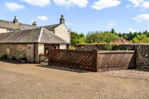 a wooden gate in front of a house at The Bothy in Dundee