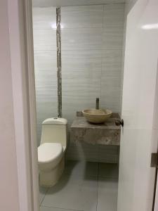 a bathroom with a toilet and a sink at Casa de la Playa in Playa Azul