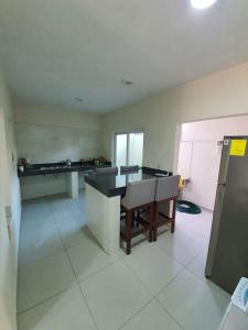 a kitchen with a table and chairs in a room at Casa de la Playa in Playa Azul