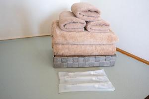 a pile of towels sitting on top of a stack of towels at 暮泊くらはく 1日 1組様限定 5名様まで宿泊可能 in Mikasa