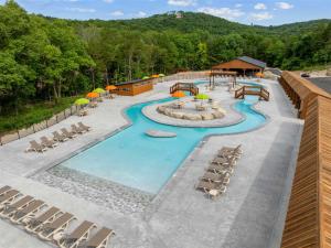 an overhead view of a resort pool with lounge chairs at LakeSides Retreat with Amenities in Hollister +44 photos