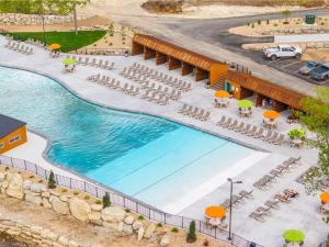 an overhead view of a pool with chairs and umbrellas at LakeSides Retreat with Amenities in Hollister