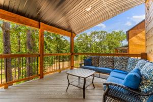 a porch with a couch and a table at LakeSides Retreat with Amenities in Hollister