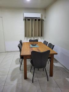 a conference room with a wooden table and chairs at Serenity Appartementen 2 in Paramaribo