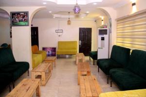 a waiting room with couches and tables in a room at MF Supreme Hotels and suites in Ikorodu