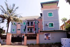 a large building with a palm tree in front of it at MF Supreme Hotels and suites in Ikorodu
