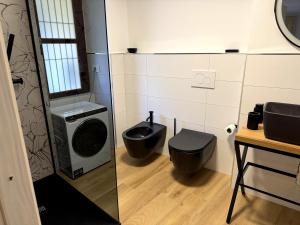 a bathroom with a washing machine and a toilet at Ca' Santa Maria in Santa Maria Maggiore +11 photos