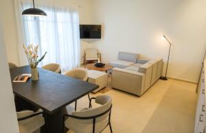 a living room with a table and a couch at Villa Artemis 2 - Etheras Properties in Kythira