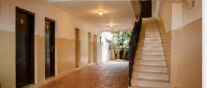 a hallway of a building with a stair case at TCHASSHOUSE Motel in Yaoundé