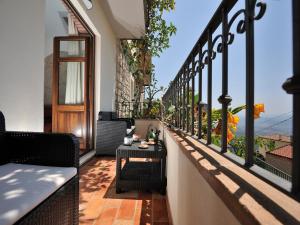 a balcony with a table and chairs on a building at Sunset Baunei in Baunei