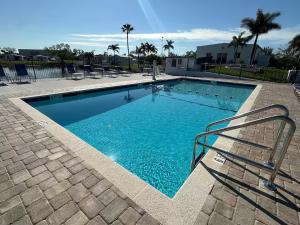 a large swimming pool with blue water at Lake Front, Beach Retreat in Fort Myers Beach