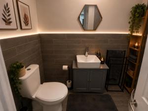 a bathroom with a white toilet and a sink at Cosy in Windsor in Windsor