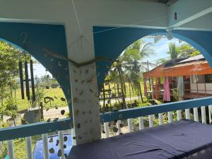 a room with a bed and a view of a park at Casa Azul by Silvia Sàmara in Nicoya