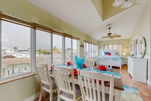 a dining room with a table and chairs and a bedroom at Diversity in Saint James City