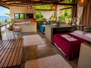 a bedroom with a bed and a desk and a kitchen at Monkey beach agroturismo in Gamboa +110 photos