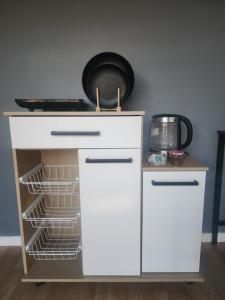 a white cabinet with a shelf and a plate on top at Tiny por trabajo in Trinidad