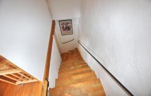 a staircase in a house with a stair case at Charmante Villa Piscine in Taulis +9 photos