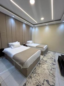 a hotel room with two beds and a couch at Casa pyramids hotel in Cairo
