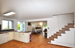 a kitchen with a staircase and a living room at Imprenable Villa Piscine in Taulis