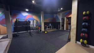 a room with a gym with a painting on the wall at Casa de Perú Iquitos- Boutique Hotel in Iquitos