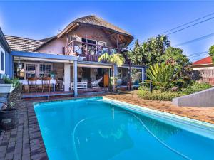 a house with a swimming pool in front of a house at Inn-Style in Cape Town