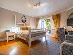 a bedroom with a bed and a table and a balcony at Inn-Style in Cape Town +52 photos
