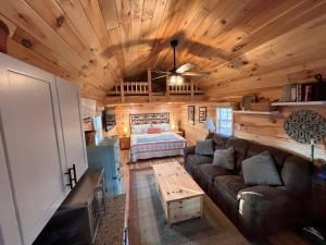 a living room with a couch and a bed at Timber Ridge Retreat in Berkeley Springs