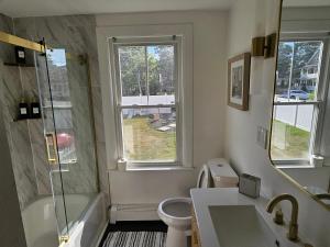 a bathroom with a shower and a toilet and a sink at Sleeps 6 Near Boston, Providence & Gillette in Attleboro +6 photos
