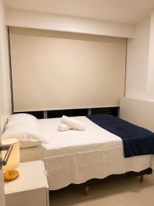 a bedroom with a bed with a towel on it at Life Center in Caruaru