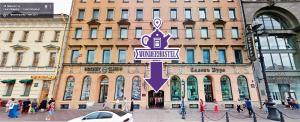 a street sign in front of a large building at WonderHostel on Nevsky 23 in Saint Petersburg
