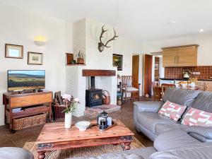 a living room with a couch and a fireplace at Beehive Cottage Culbone in Porlock