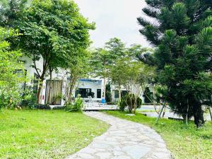 a walkway in front of a house with trees at Solmist Villa in Hòa Bình +92 photos