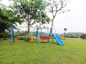 a playground with a slide in a park at Solmist Villa in Hòa Bình