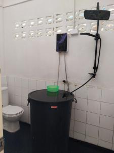 a room with a toilet and a camera in a bathroom at Honey You HOSTEL in Ban Khlong Mat