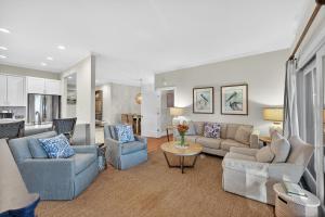 a living room with couches and chairs and a kitchen at SS3512: 3512 Seascape in Kiawah Island