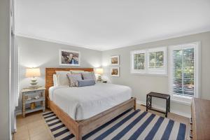 a bedroom with a bed and two windows at SS3512: 3512 Seascape in Kiawah Island