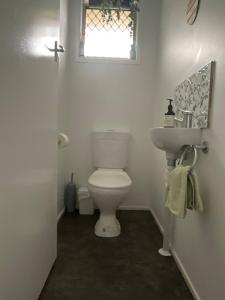 a bathroom with a toilet and a sink and a window at Marigold House in Rockville