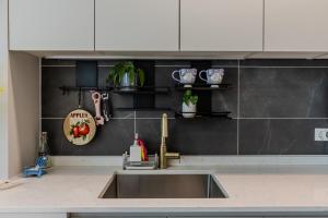 a kitchen with a sink and a counter top at 광안리 써니 스테이 #무료주차 in Kwangan-dong +19 photos