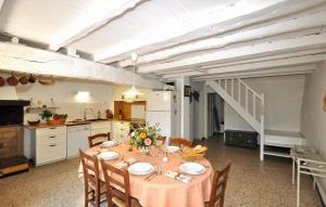 a kitchen with a table and chairs in a room at Authentique Villa Piscine in Taulis