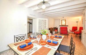 a dining room with a table with plates and wine glasses at Authentique Villa Piscine in Taulis