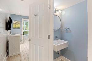 a white bathroom with a sink and a mirror at SS3524: 3524 Seascape in Kiawah Island