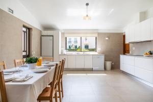 a kitchen and dining room with a table and chairs at Vilamoura Escape with Private Pool in Vilamoura
