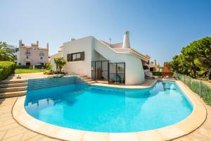 a swimming pool in front of a house at Vilamoura Escape with Private Pool in Vilamoura