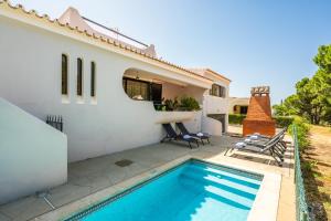 a villa with a swimming pool and a house at Vilamoura Escape with Private Pool in Vilamoura