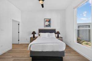 a white bedroom with a bed and two windows at Sonoran Oasis with Pool, Spa & BBQ Area in Phoenix +57 photos