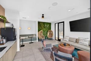 a living room with a couch and a tv at Sonoran Oasis with Pool, Spa & BBQ Area in Phoenix