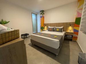 a bedroom with a large bed in a room at Hotel Medallo City in Medellín