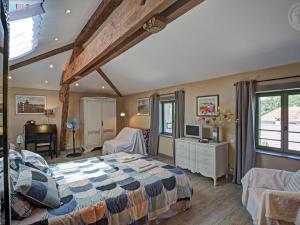 a bedroom with a large bed and a piano at Gîte au cœur d'un village médiéval, charme et confort moderne - FR-1-496-125 in Chagnon +28 photos